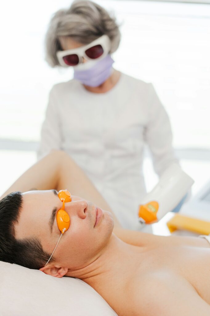 Mature woman, doctor cosmetologist using laser, facial skin treatment, acne, rejuvenation