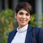 Portrait confident hispanic business woman smiling in city success testimonial